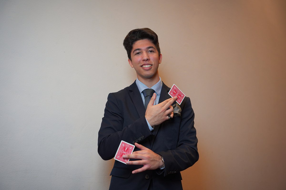 TDog producing two playing cards from mid-air